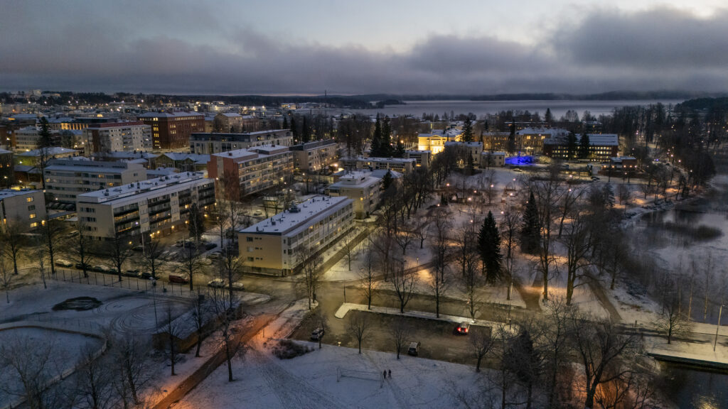 Iltahämärässä näkyviä kaupungin valoja, rakennuksia keskustassa.