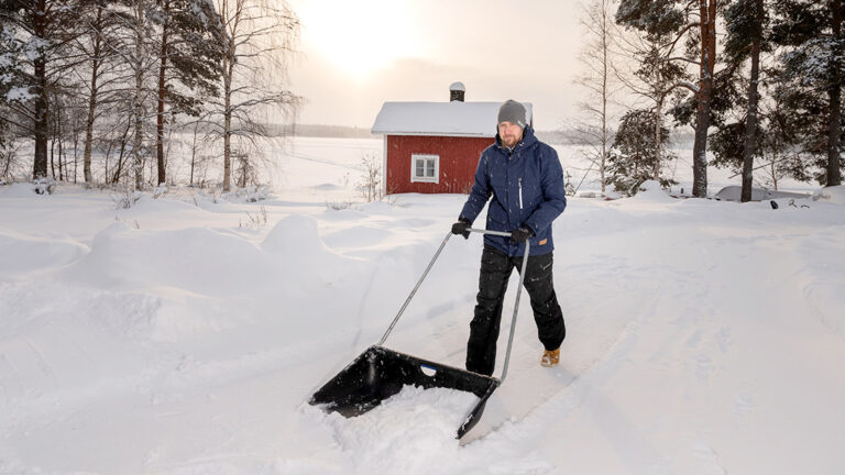 A man is shoveling the road.